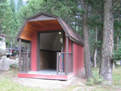 Red barn style shed that is used to house video games at an RV site near Radium Hotsprings