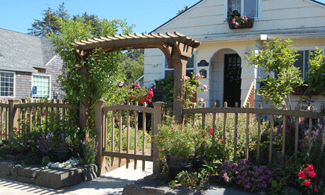 This cedar arbor with gate provides a nice entry way into the house and garden