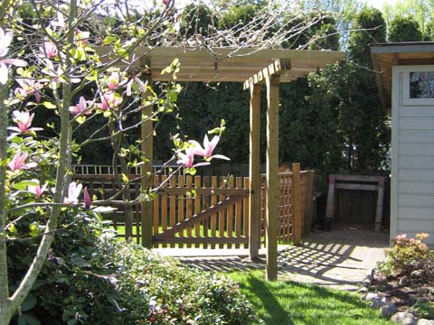 This wood garden arbor is built with a gate to provide an entryway into our friend's backyard.